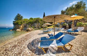 Sun beds Glyfada Beach Villas at Monodendri Beach